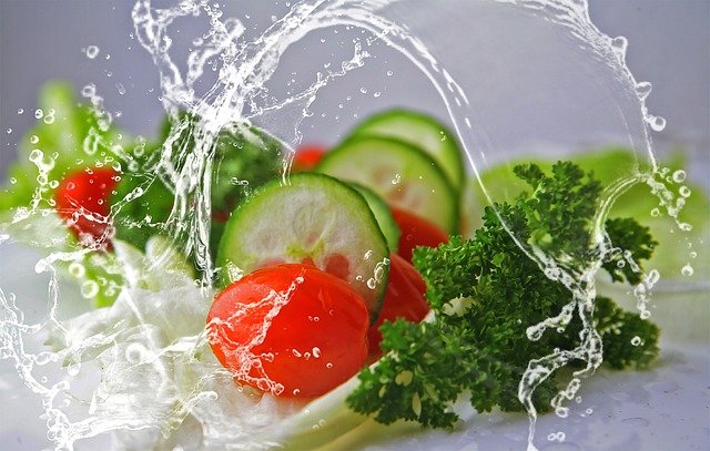 Fresh vegetables splashed with water, creating a vibrant and refreshing scene